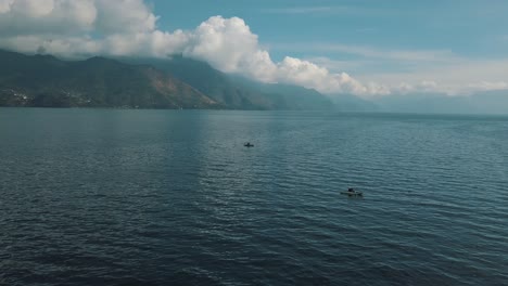 drone aerial view of fishing vessel in the beautiful lake atitlan, guatemala