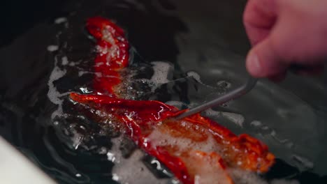 frying a red pepper in oil