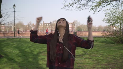 attractive young female celebrating good news on her mobile phone