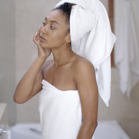 woman looking on the mirror after shower