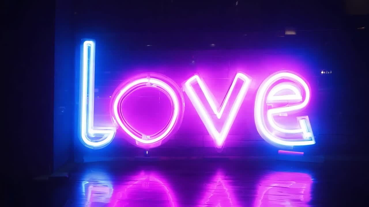 Neon sign featuring the word love in blue and pink lights blinks rhythmically, creating a romantic atmosphere