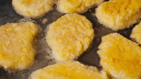 potato pancakes frying in a pan