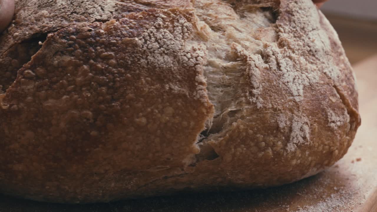 Slicing Freshly Baked Crusty Bread with Serrated Knife