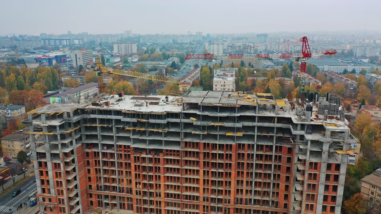 Construction site of modern multi-storey building in the city. Aerial panoramic view on a construction of a new building.