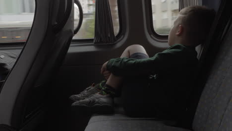 child looking out the window during car journey