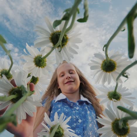 child admires wildflowers