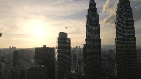 skyline at sunset with petronas twins tower and modern skyscraper building aerial drone