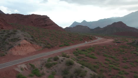 Aerial---Highway-and-mountains,-Cafayate,-Argentina,-wide-circle-shot