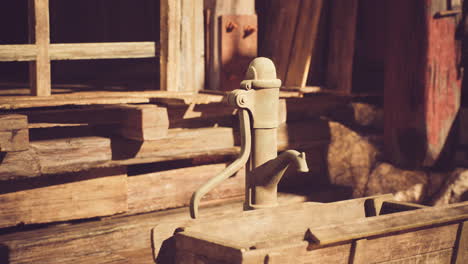 vintage water pump in an old wooden structure during golden hour sunlight