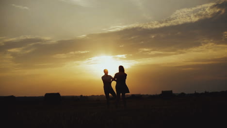 romantic couple at sunset. young couple enjoying the sunset in the meadow