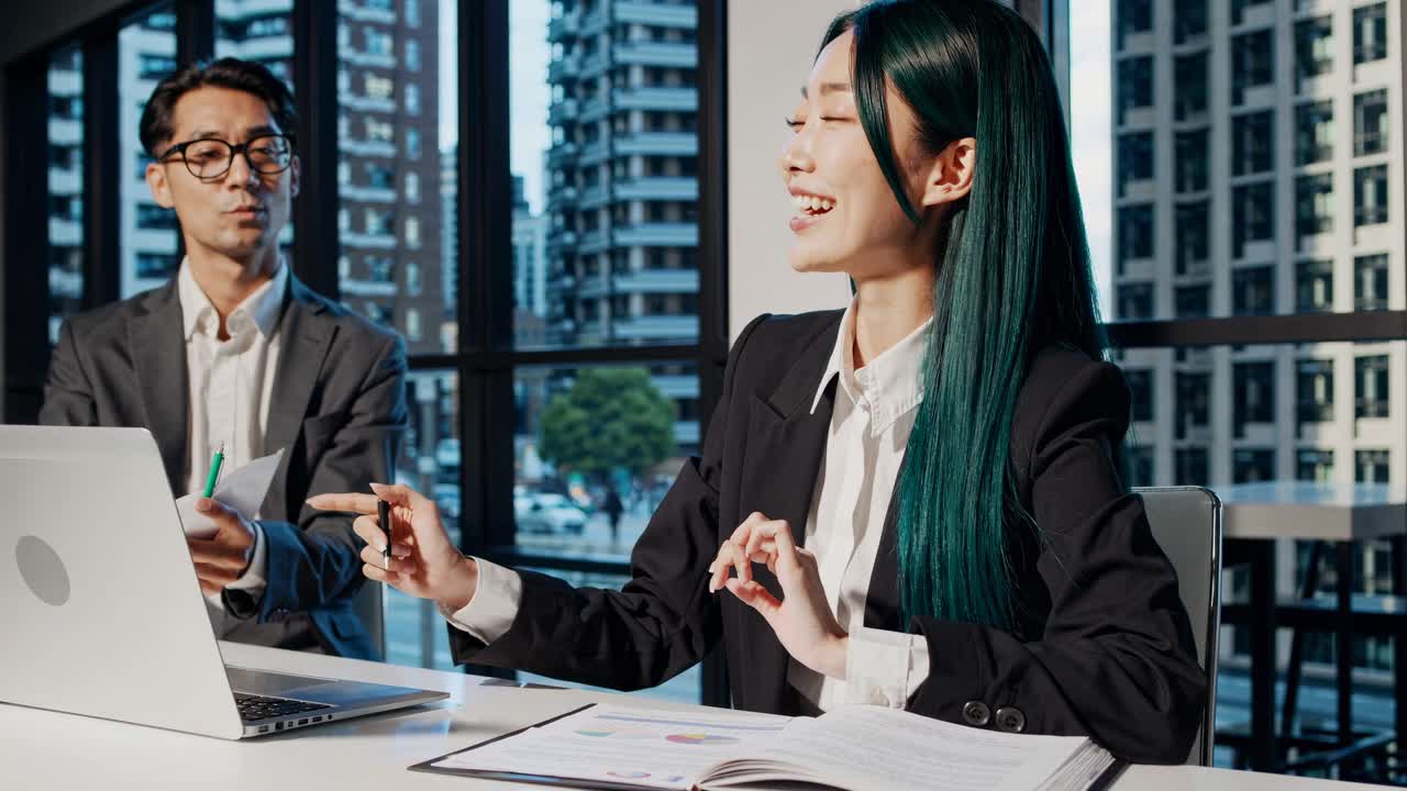 Business meeting video with a low-angle shot, featuring two professionals in a modern office