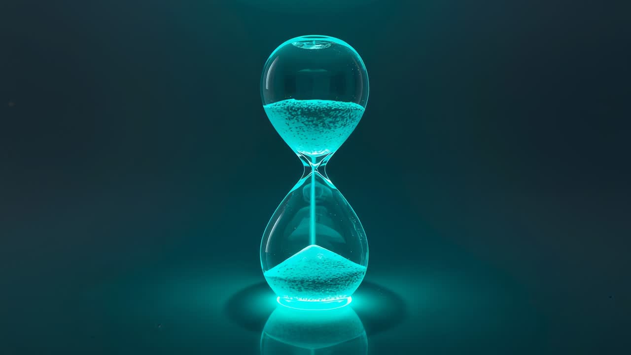 Fading in glass hourglass pouring glowing sand on reflective tabletop, signaling time passage