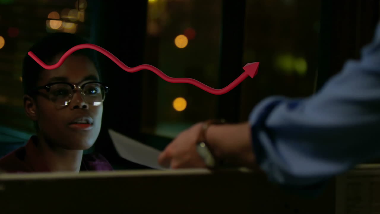 Animation of arrow over african american businesswoman working in office