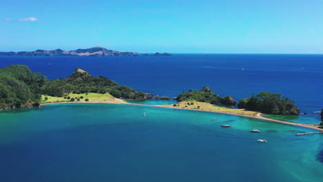 aerial view of boats and yachts in roberton island in bay of islands of new zealand - motuarohia island with calm blue sea in summer