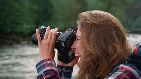 photographer taking pictures of nature. excited woman using photo camera outdoor