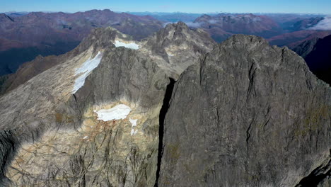 wide-mountains-drone-shot-Milford-Sound-Gertrude-Saddle-Fiordland-National-Park,-New-Zealand