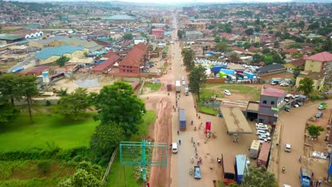 Aerial-Panorama-Of-Traffic-Driving-Over-The-Road-Near-Industrial-Area-In-Kampala-City,-Uganda