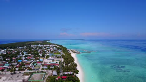 一座加勒比海島的景色, 有一個小鎮, 棕<unk>樹和白色的海灘,