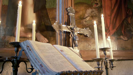 antique prayer book with candles and church interior background