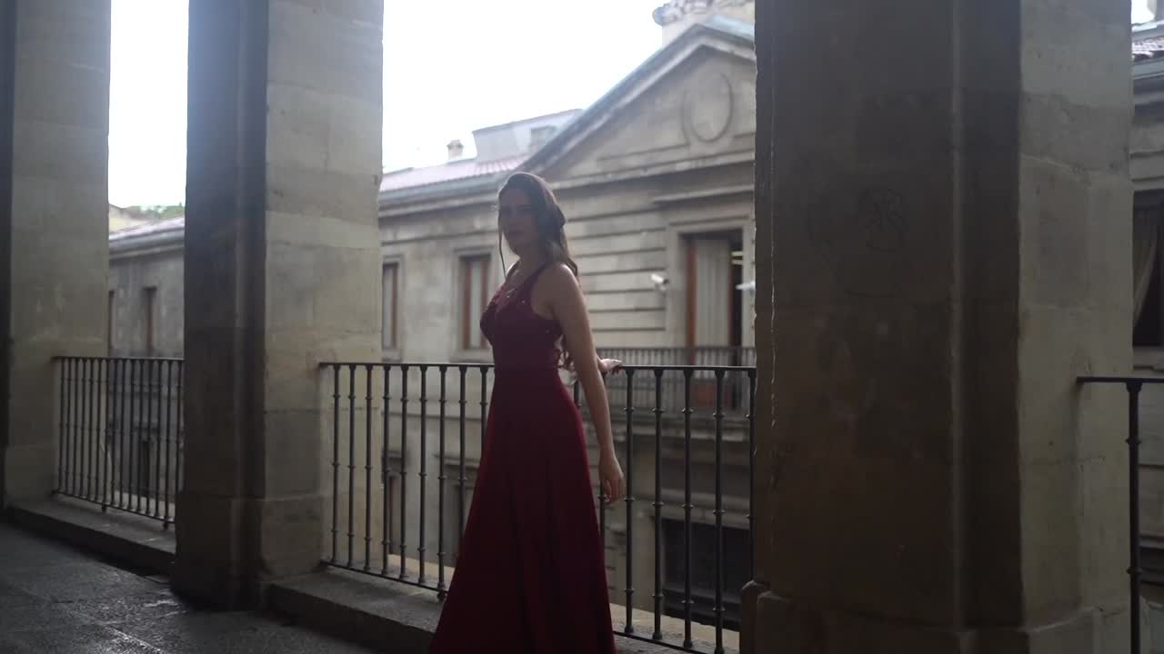 Woman in Red Dress on Balcony
