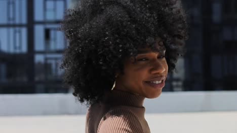 60-fps-slow-motion-beautiful-african-american-model-dancing-on-rooftop-in-los-angeles-la-panning-up-and-down-body-with-big-hair