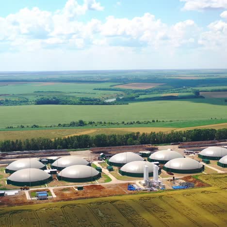 flight around biogas power plant. aerial drone footage of biogas plant at countryside