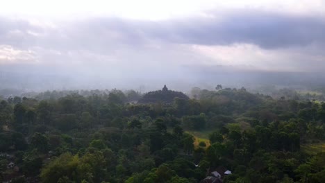 Cinematic-dolly-slide-of-buddhist-temple-Borobudur,-shrouded-in-clouds