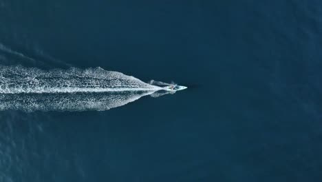 aerial view of a solo skiff in blue water