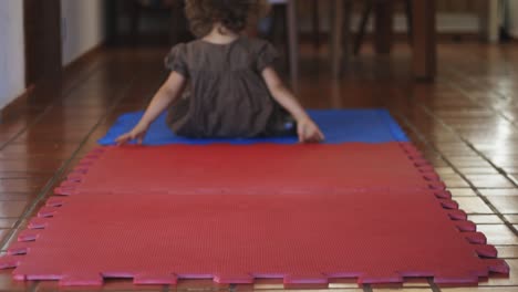 young 4 year old cute girl doing back tumble flips on the ground