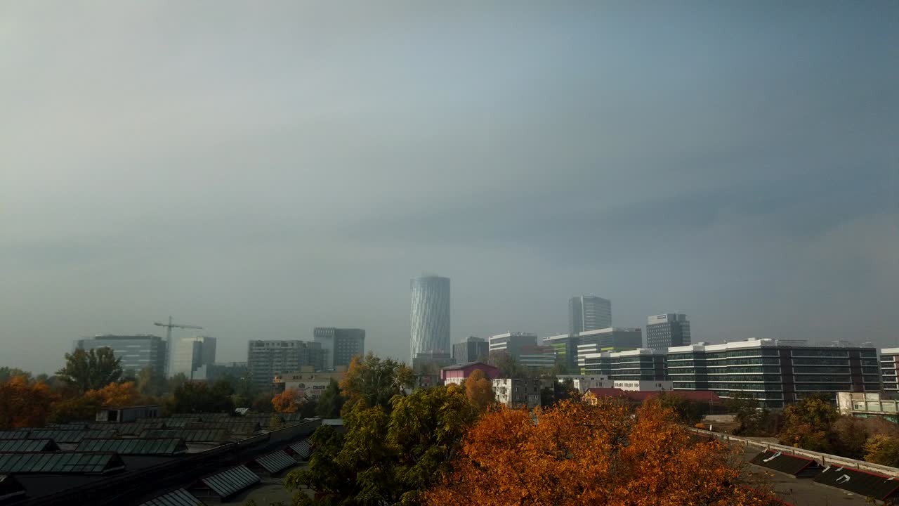 Bucharest, Romania - October 20, 2019 : Office buildings in North part of Bucharest clouds with fog motion time lapse