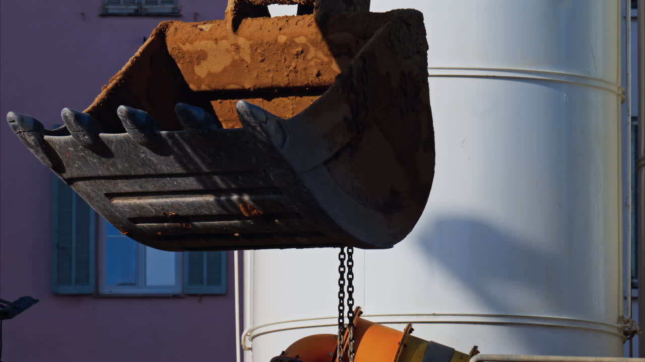 Close up of a yellow crane machine moving and lifting on a construction site