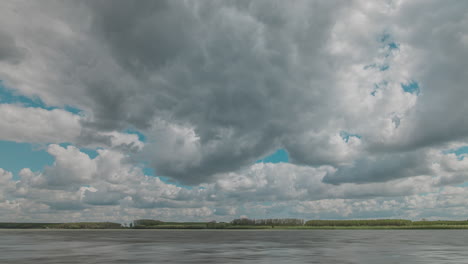timelapse with cloudy blue skies over big river on a sunny day, hdr