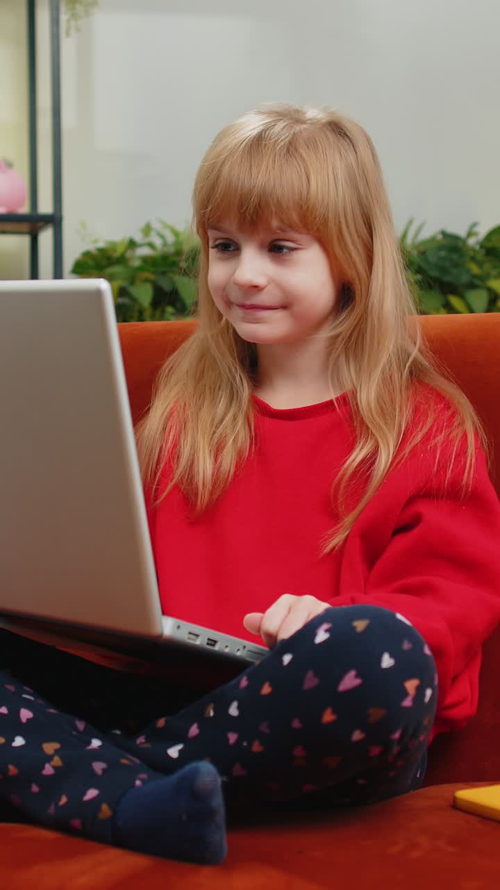 Preteen child girl looking at laptop camera making video webcam conference call with friends family