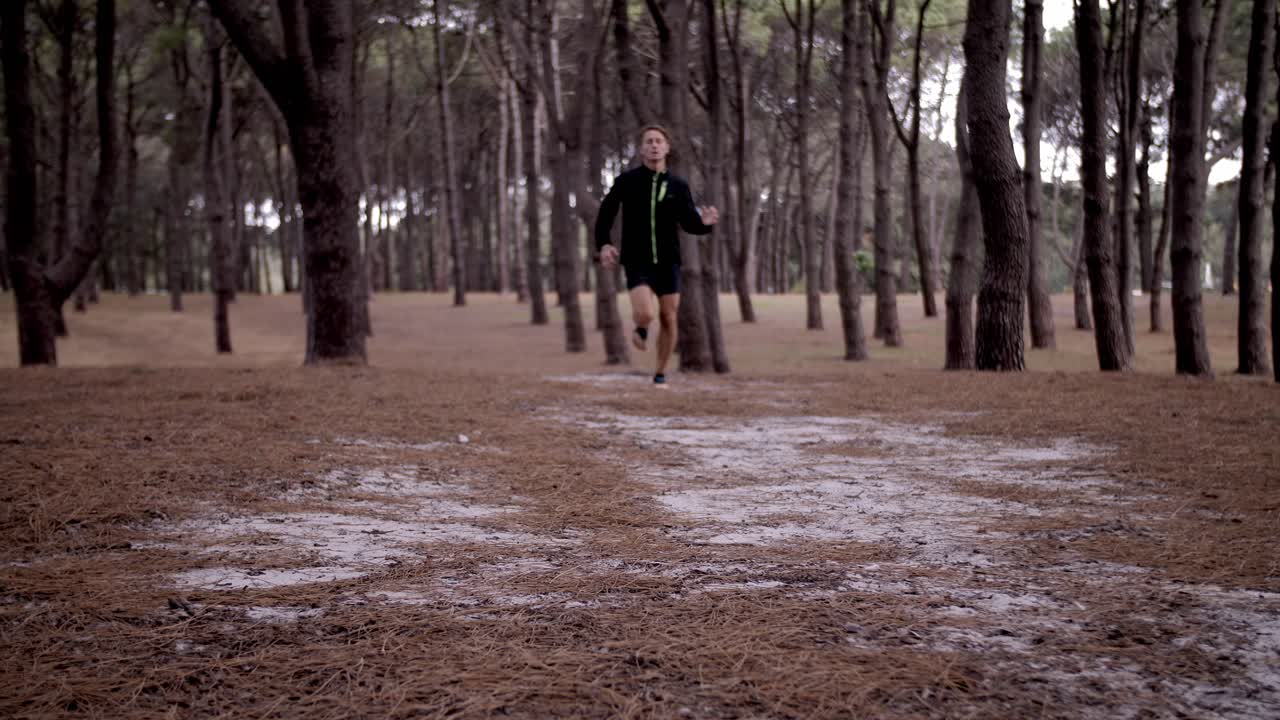 Feet of Man swiftly jogging with Pine Tree Forest Surrounding Him