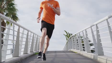 sporty caucasian man training on a bridge