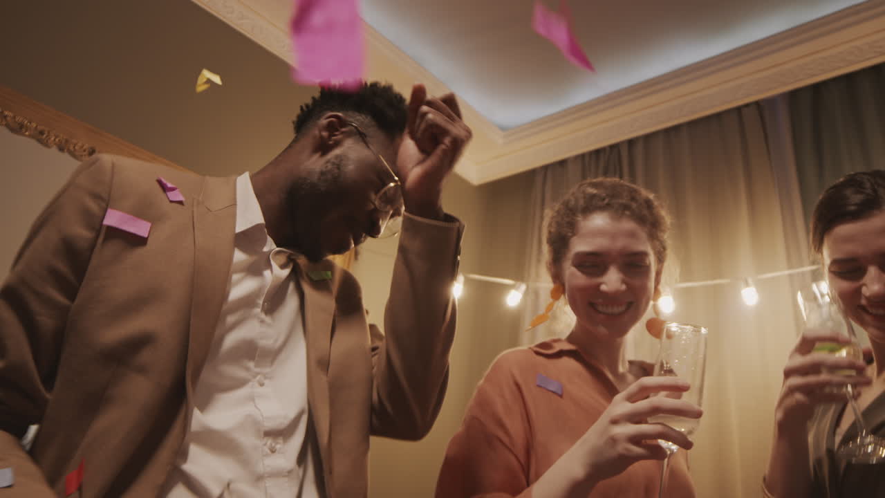 Friends Dancing with Confetti at House Party