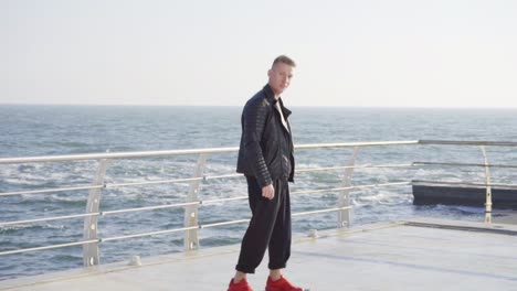 young man skating by the sea