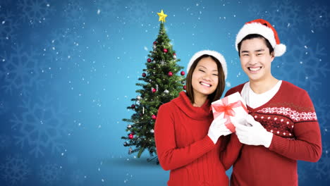 christmas winter couple with christmas tree and gift