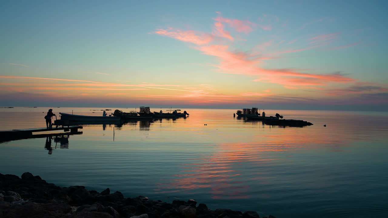 Serene Sunset over Calm Sea with Fishing Boats