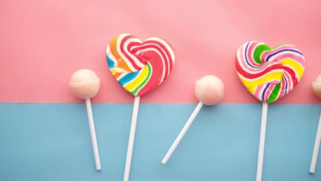 rainbow heart shape lollipop on color background