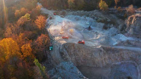 limestone mine. aerial view of the limestone mine with trucks and machines working in it. caucasus mountains in russia