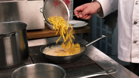 chef preparing pasta dish