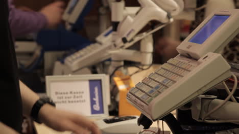 handheld-shot-of-a-cashier-at-a-register