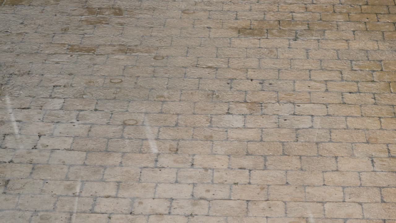 Heavy rain drops pouring on paved road, bad wet downpour weather on driveway