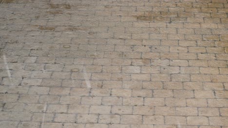 heavy rain drops pouring on paved road, bad wet downpour weather on driveway