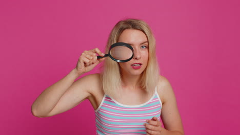 Amazed-excited-woman-hold-magnifying-glass-near-face-looking-at-camera-with-big-zoomed-eye-analyzing