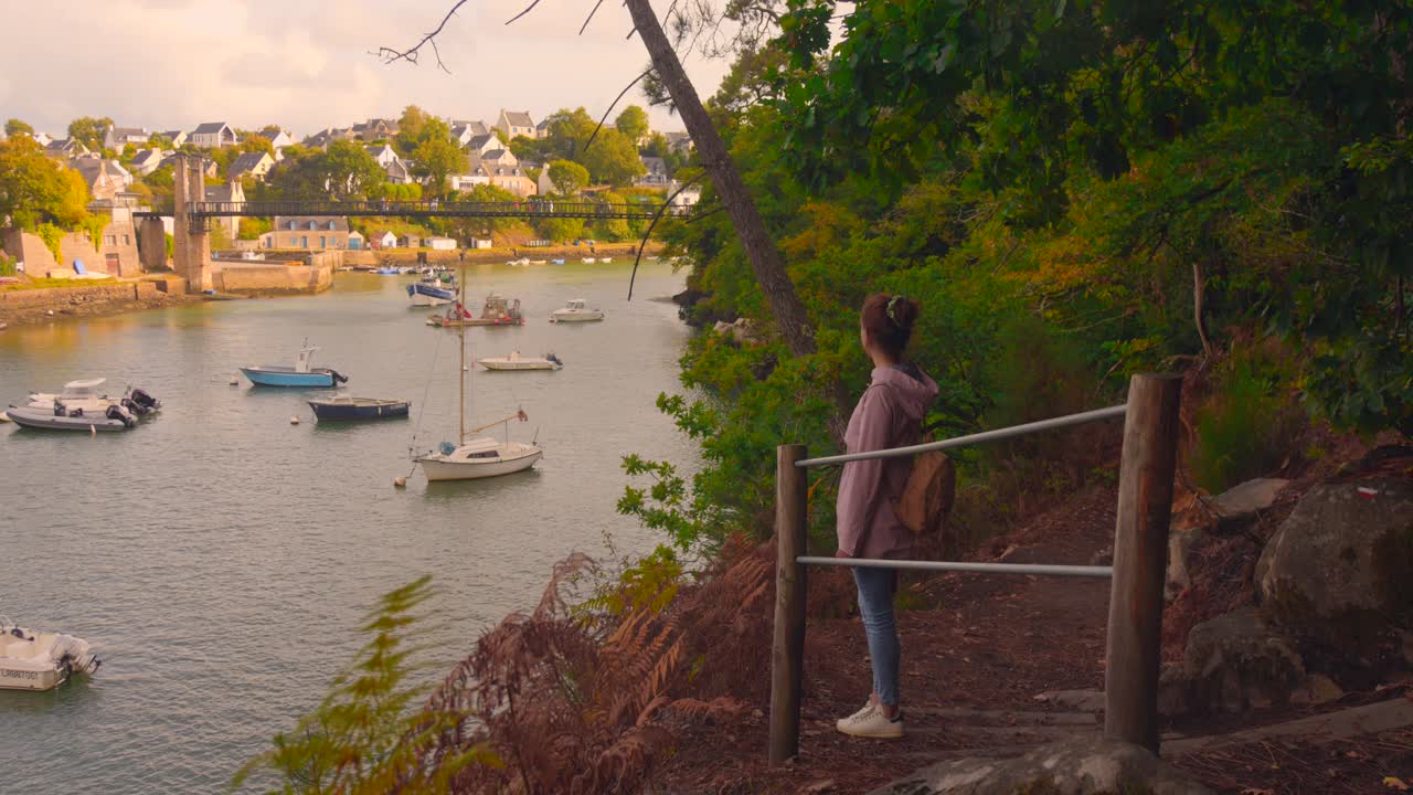 Girl enjoys view of boats in Le Bono, a picturesque Brittany town