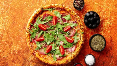 Tasty-pizza-on-a-rusty-background-with-spices--herbs-and-vegetables