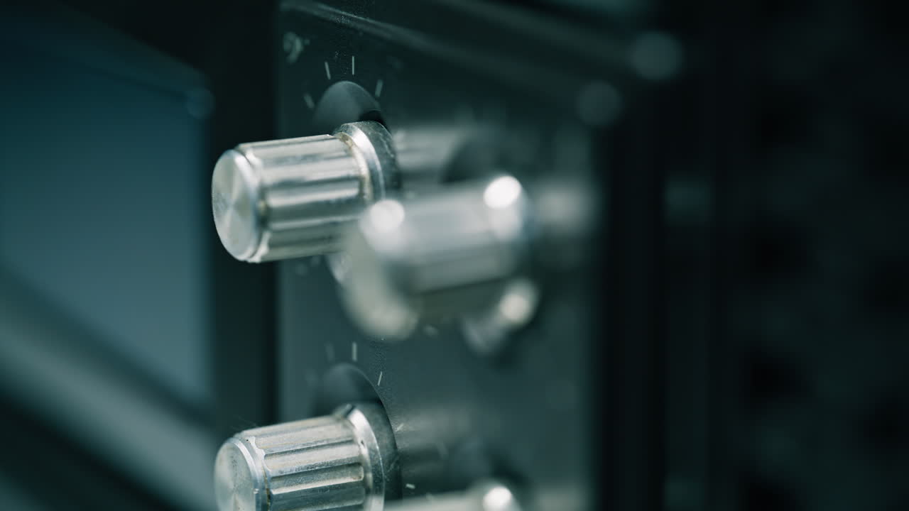 Closeup vintage radio knobs. Dial reflecting light. Traditional music equipment