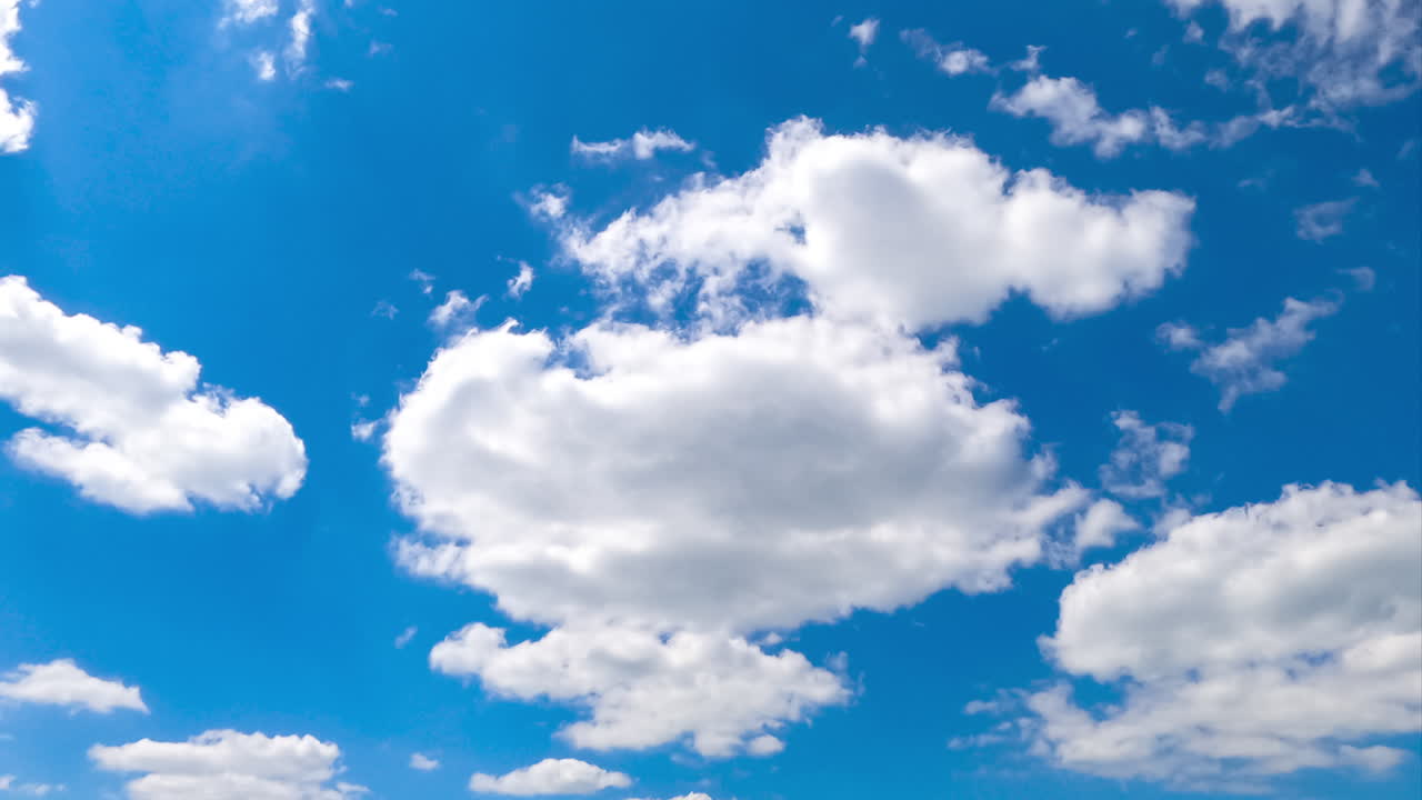 Wonderful blue sky with clouds quickly changing shapes. Beautiful cloudscape timelapse view from below.